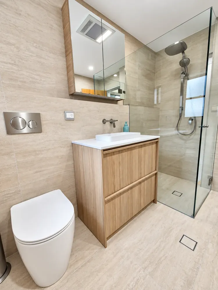 Sans Souci bathroom with mirrored shaving cabinet, oak vanity and rainfall shower