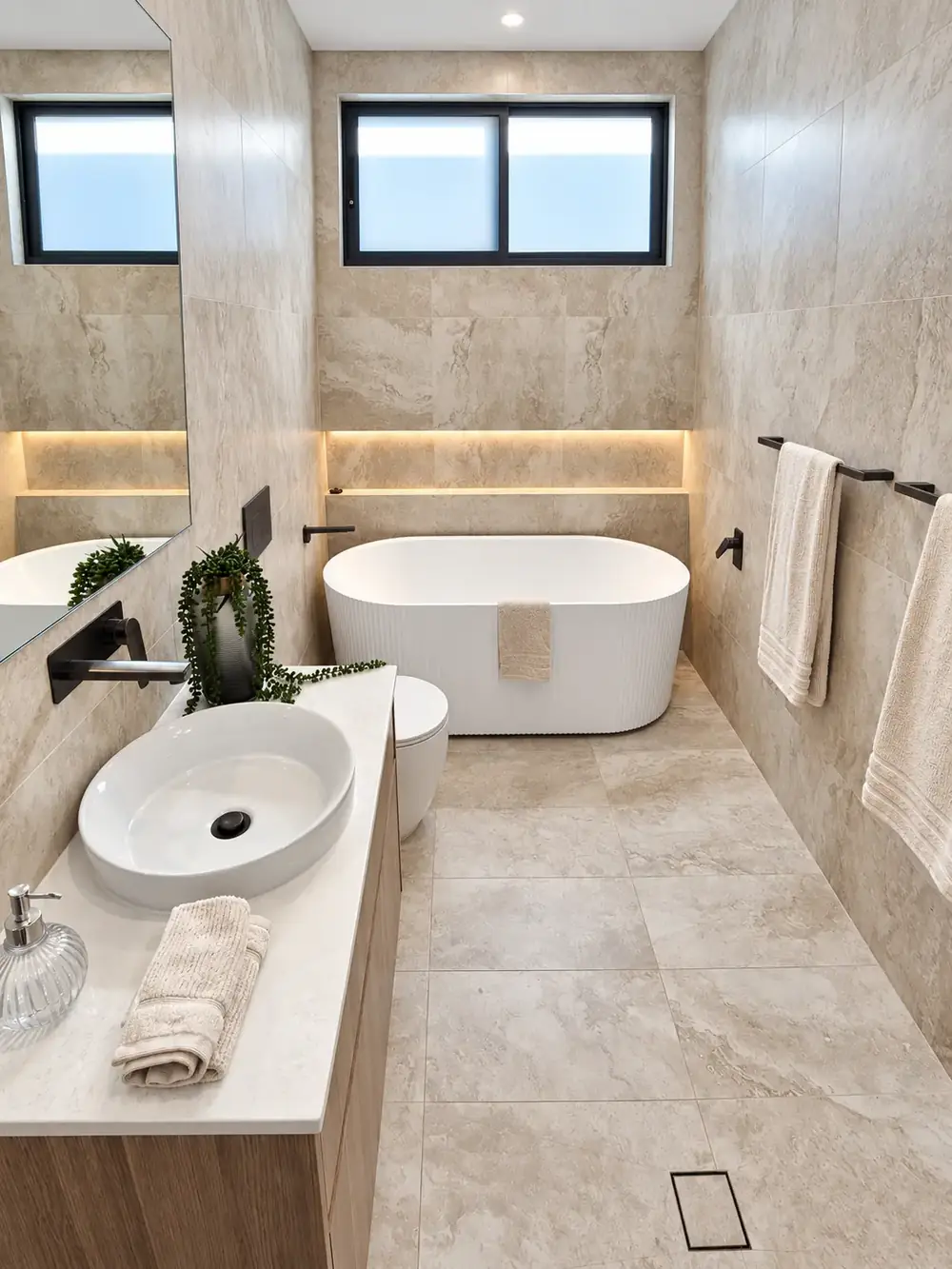 Picnic Point main bathroom with fluted freestanding bath and backlit niche