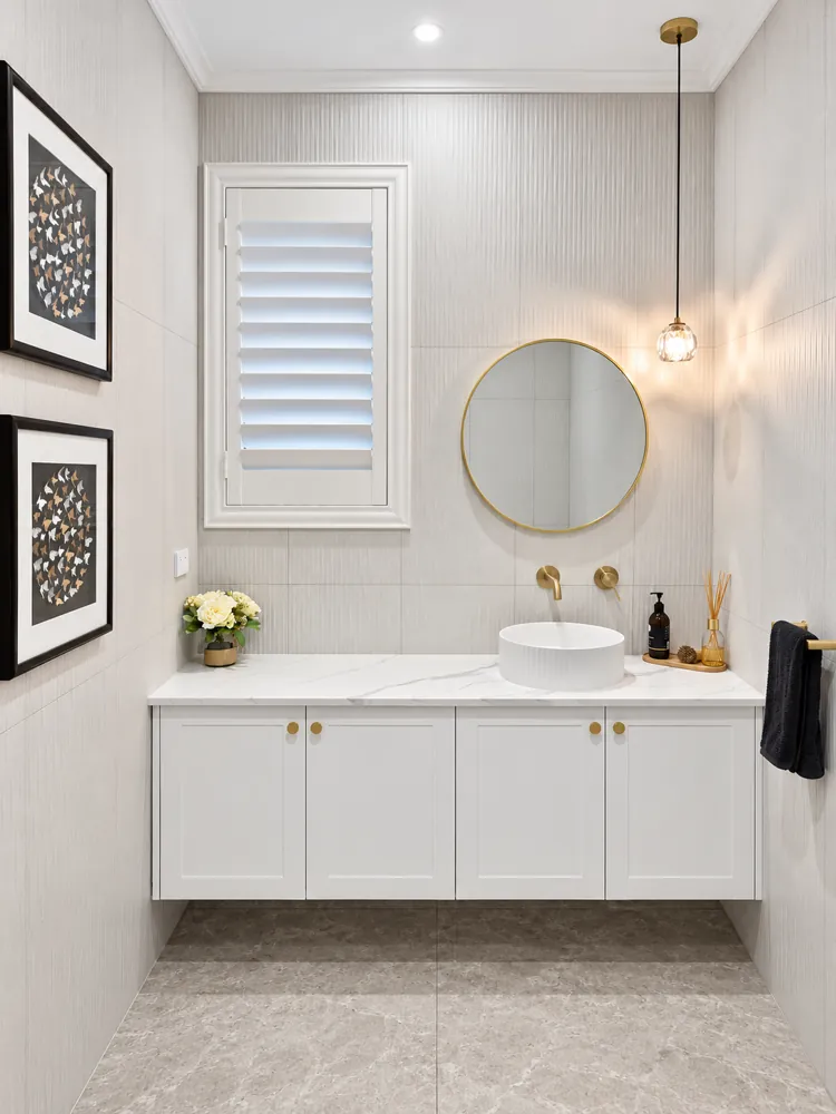 Panania powder room with fluted basin, brass tapware and pendant light