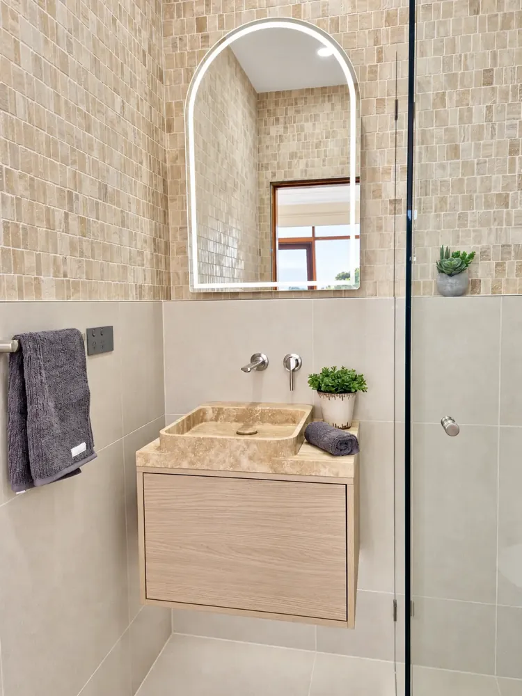 Sans Souci bathroom vanity with stone basin, floating oak cabinet and arched LED mirror