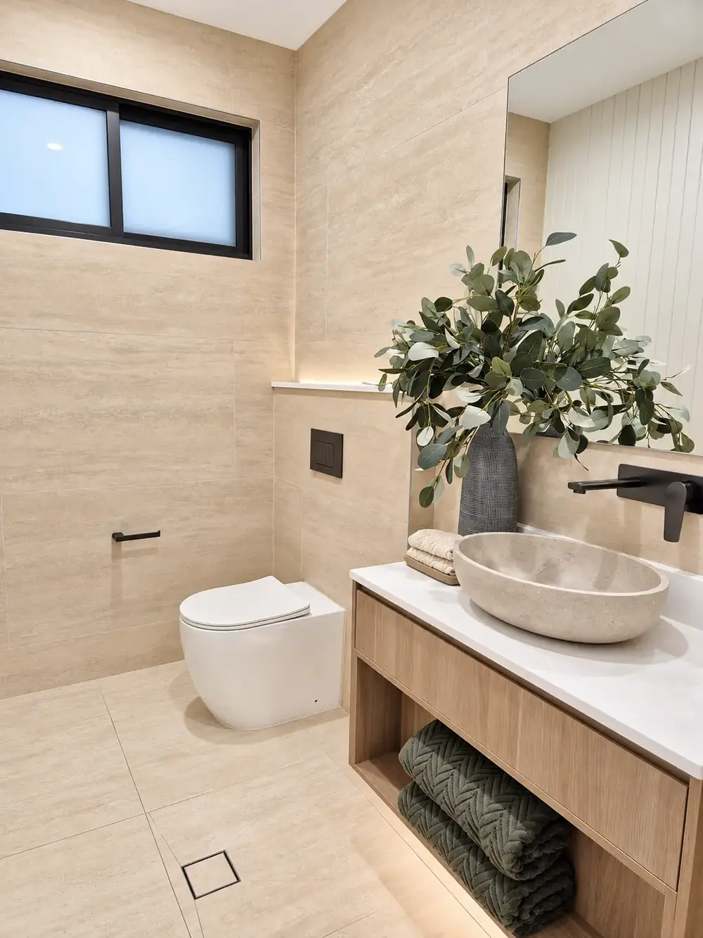Picnic Point bathroom in travertine tones with stone basin and timber vanity