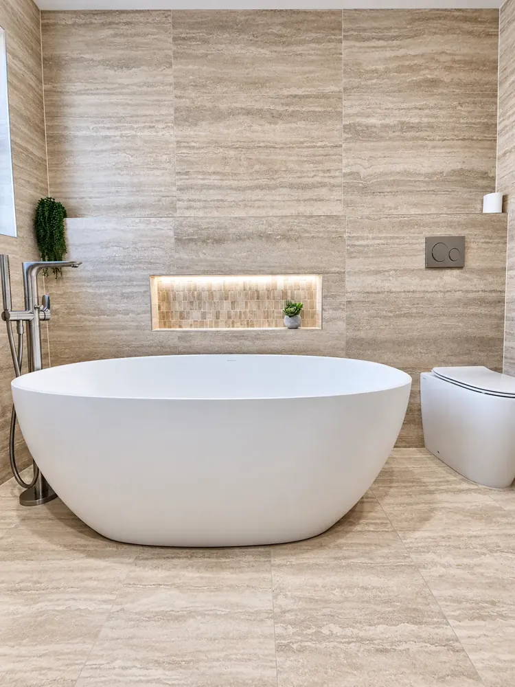 Sans Souci main bathroom with freestanding stone bath and travertine-look tiles